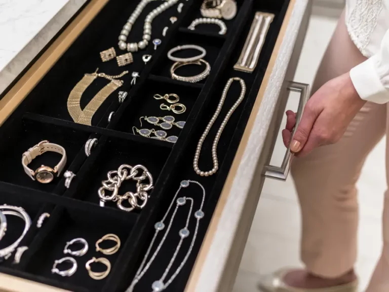 jewelry drawer displaying necklaces, watches, and earrings
