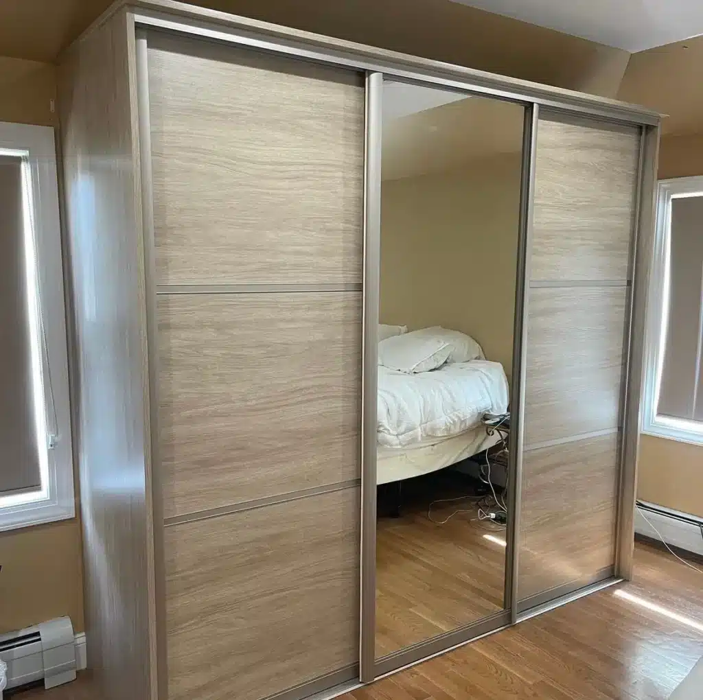 small wardrobe with sliding doors and built in mirror in the middle door